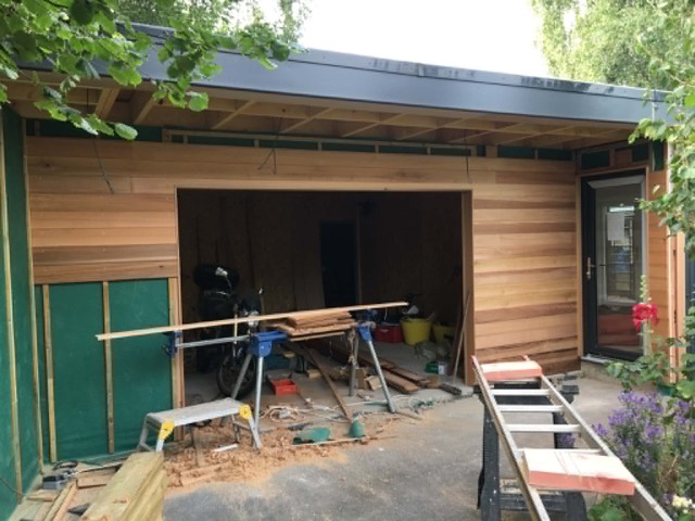 Cedar-clad garden building under construction