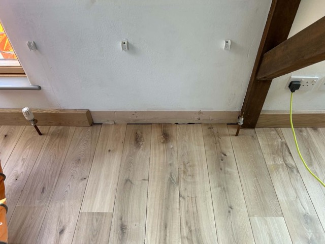Oak floor beneath exposed beams